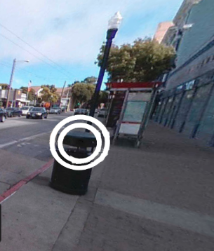 With EASY MODE on, the surveillance devices will be highlighted as above. (This is an example of the highlighting—the trash can is not a surveillance device.) This is an image from the spot the surveillance application. There is a trash can with two white circles around it.