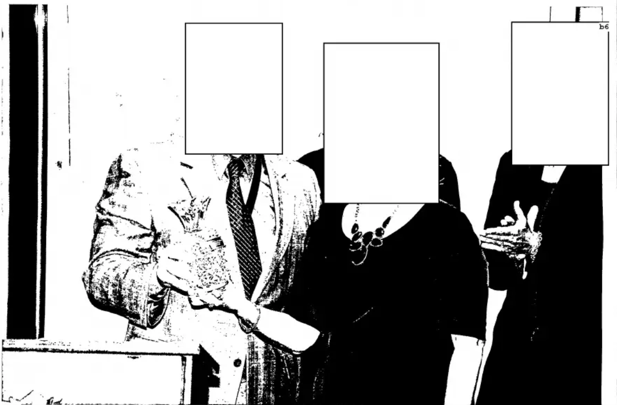 A photo from a retirement party with white boxes over the attendees' faces. A photo from a retirement party with white boxes over the attendees' faces.